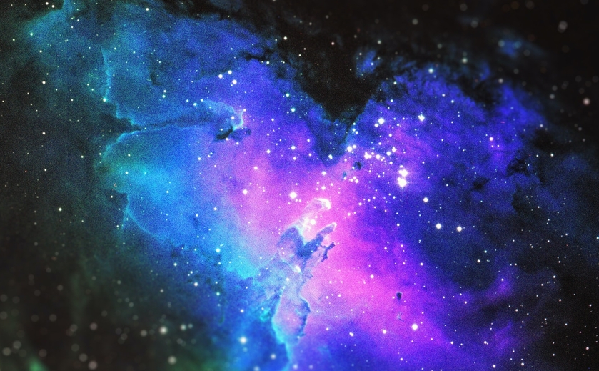 a pink, blue, and purple nebula surrounded by stars.